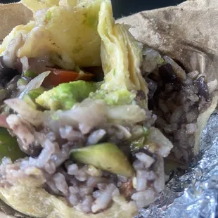 Vegetariano Burrito, with cut cucumber and cut slices of tomato with white rice