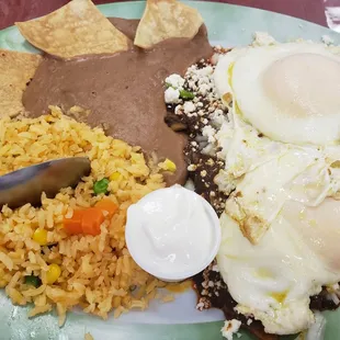 Mole chilaquiles with medium cook eggs  Chilaquiles have only queso fresco and onion