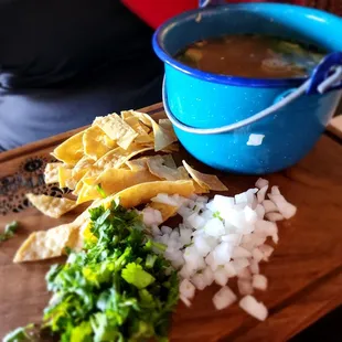 a bowl of soup and tortilla
