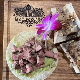 a steak taco and a flower