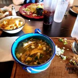 a bowl of soup with tortillas