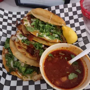 a plate of tacos and a bowl of salsa