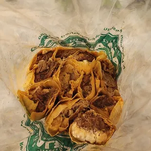 a hand sprinkles the tortilla