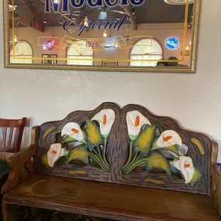 a wooden bench with flowers painted on it