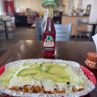 a bottle of soda and a plate of nachos