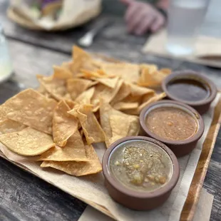 Chip and salsa. There is mole, warm roasted tomato salsa and a puréed pico