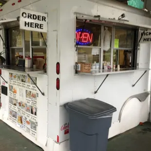a food stand with a trash can