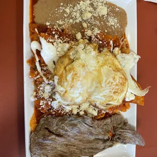 Chilaquiles with red sauce and steak.... Yum!