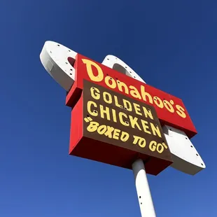a sign for donahoo's golden chicken