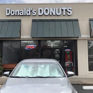 a car parked in front of a donut shop