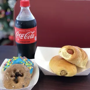 Large sausage a cheese croissant, Boudin, blueberry cake, fruity pebbles blue donut, and a coke!