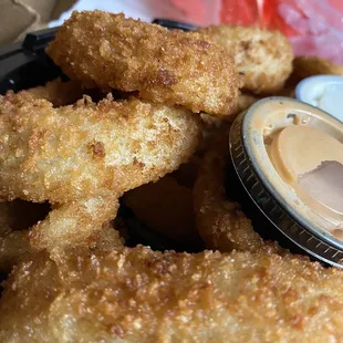 a plate of fried fish sticks and dipping sauce