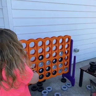 a little girl playing a game of connect