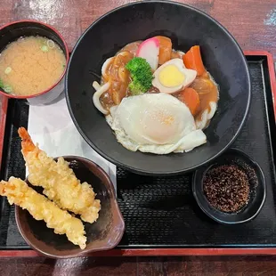 Curry udon with shrimp tempura and fried egg