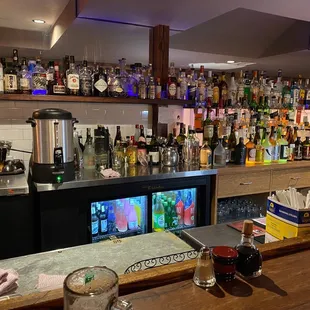 a bar with many bottles of alcohol