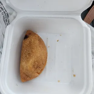 a donut in a styrofoam container