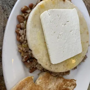 Columbian breakfast. Arepa, queso. Rice and beans. Chicken. Highly recommended.