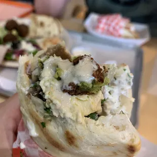 Chicago Style Gyro with lamb and feta cheese. This amazing gyro was topped with tabouli, hummus, falafel &amp; tahini sauce.... AH-MAZING!