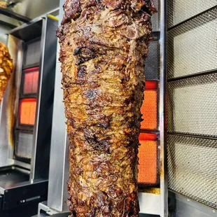 the meat being cooked in a commercial kitchen