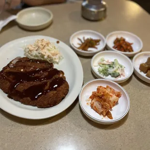 a plate of meat, rice, and vegetables