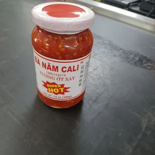 a jar of hot sauce on a counter