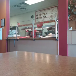 a counter with a menu in the background