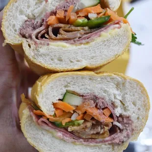 a person holding a sandwich