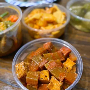 three bowls of food on a table