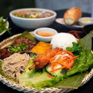 C1. Com Tam Bi Suon Cha Rice Plate: choice of broken/whole rice, shredded prok skin, shrimp cake on sugarcane, and sunny shine egg ($23.49).