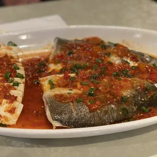 a plate of fish with sauce