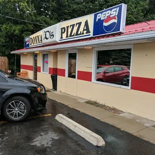 a car parked in front of the restaurant