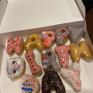 Bday donuts def a rush job with icing running everywhere and I asked for bright, fun colors with 2 heart donuts on the side.
