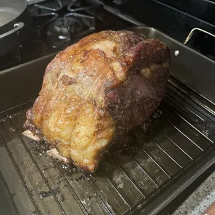a roasting pork on a grill
