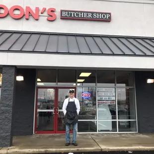 a woman standing in front of the store