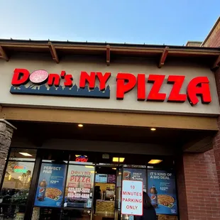 a man standing in front of a restaurant