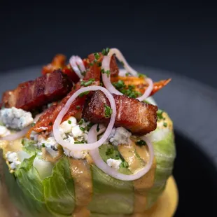 a salad with bacon and cheese