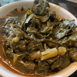 a bowl of stew and greens