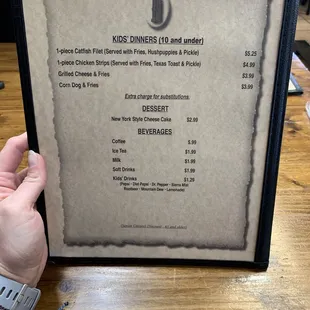 a hand holding a menu