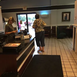 two people standing at the counter