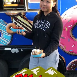 a woman holding a donut