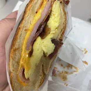 Ham, Bacon, Egg, & American cheese on a croissant.
