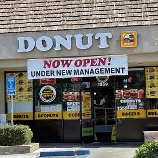 a donut shop with a donut sign