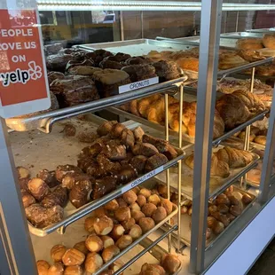 a variety of donuts in a display case