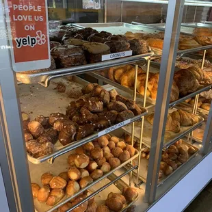a variety of donuts in a display case