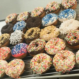 a variety of donuts on a cooling rack