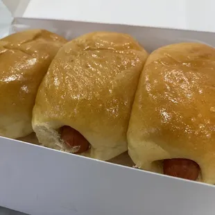four hot dogs in a box