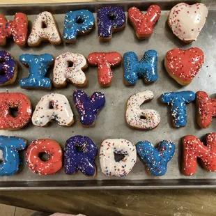 a tray of happy birthday donuts