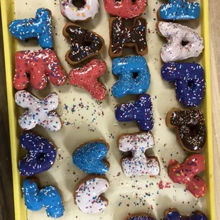 a tray of doughnuts with sprinkles