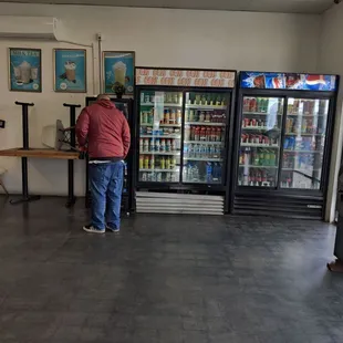 a man standing in front of a vending machine