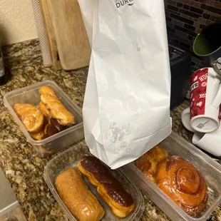 a person holding a bag of donuts